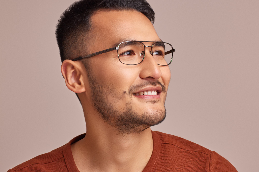 Dusty eyeglasses frame worn by model.